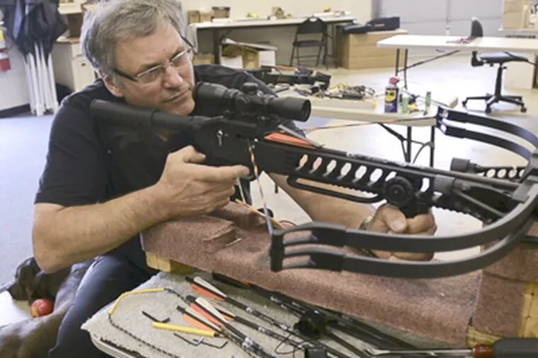Chuck Matasic, president of Kodabow, tests one of his crossbows in his W. Chester facility. He sees a growing use of crossbows in hunting. (Ron Tarver / Staff Photographer)