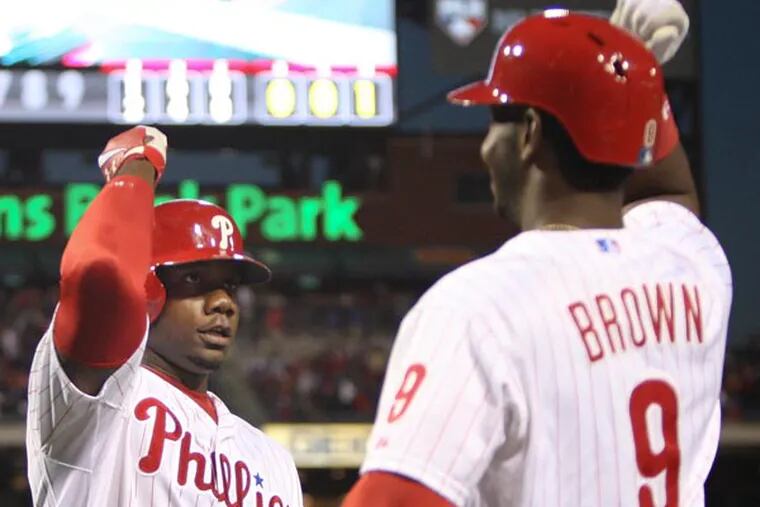 Ryan Howard (6) celebrates with teammate left fielder Domonic Brown (9) after hitting a solo homer against the Marlins during the fourth inning at Citizens Bank Park in Philadelphia, Thursday, May 2, 2013. (Steven M. Falk/Staff Photographer)