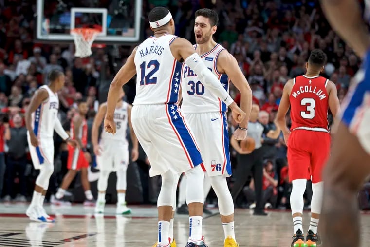 Sixers reserve guard Furkan Korkmaz, right, and forward Tobias Harris react after Korkmaz made a game-winning basket against the Portland Trail Blazers with .4 second left Saturday night in Portland.
