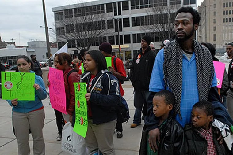 Students and parents protest Friday against proposed state budget cuts in front of the Philadelphia School District offices on Broad Street.  Here, from left to right, are: Ayesha Vasquez, 16; Jessica Elkins, 17; Taisha Martinez, 15; Kyheem Allen-Dixon, 6; Kenneth Dixon; and Kyleff Allen-Dixon, 4. Kenneth is the father of the two little boys. (April Saul / Staff Photographer)