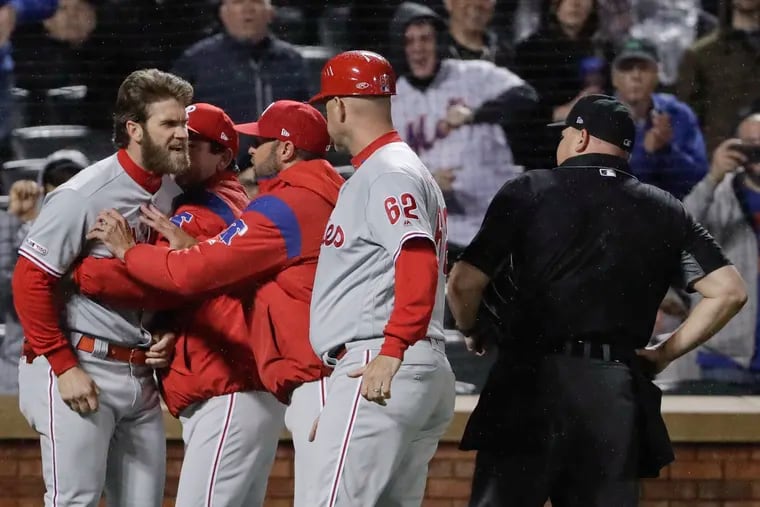 Bryce Harper gets restrained by manager Gabe Kapler while getting into it with an umpire.