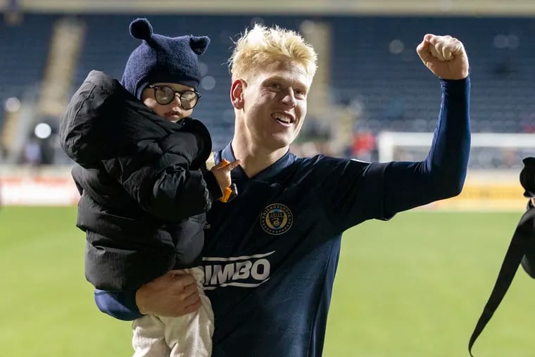 Jakob Glesnes on the field with his son after the Union's first-round playoff win over the New York Red Bulls.