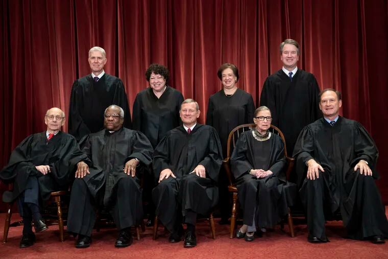 FILE - In this Nov. 30, 2018, file photo, tThe justices of the U.S. Supreme Court gather for a formal group portrait to include the new Associate Justice, top row, far right, at the Supreme Court Building in Washington, Friday, Nov. 30, 2018. Seated from left: Associate Justice Stephen Breyer, Associate Justice Clarence Thomas, Chief Justice of the United States John G. Roberts, Associate Justice Ruth Bader Ginsburg and Associate Justice Samuel Alito Jr. Standing behind from left: Associate Justice Neil Gorsuch, Associate Justice Sonia Sotomayor, Associate Justice Elena Kagan and Associate Justice Brett M. Kavanaugh.  The Supreme Court announced Aug. 23, 2019, that Ginsburg has been treated for a malignant tumor. (AP Photo/J. Scott Applewhite, File)