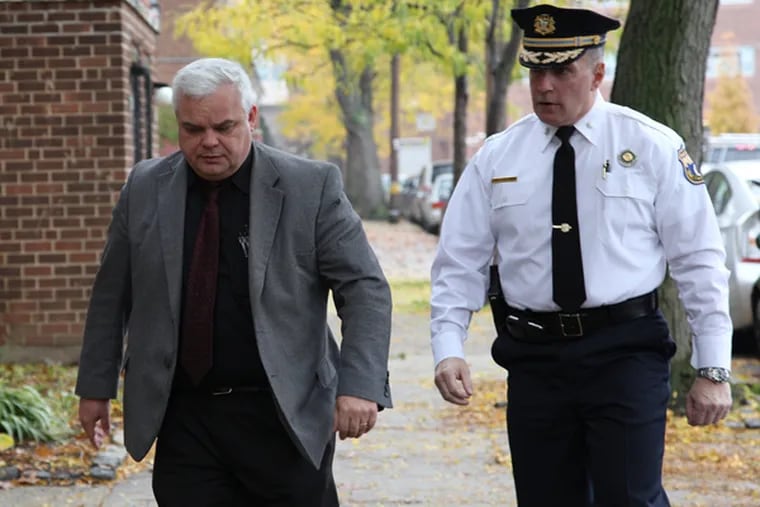 Philadelphia Lt. Robert Otto, left, and Inspector James Kelly, right, walk to the home of Keisha Gaither, the mother of abduction victim Carlesha Freeland-Gaither, in Philadelphia, Nov. 6, 2014.  (Staff  / Jessica Griffin)