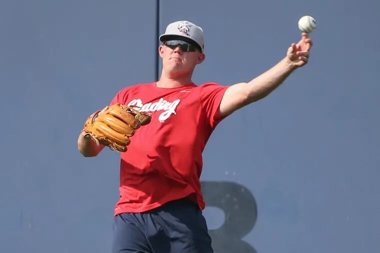 Reading Fightin Phils pitcher Garrett Cleavinger .shags fly balls before his game with the Harrisburg Senators on August 3, 2017.
