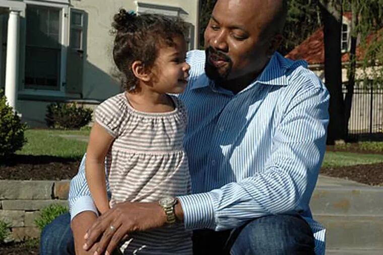 Billy King spends time with his 2-year-old daughter Natane outside their Haverford home. (Tiffany Yoon/Staff Photographer)