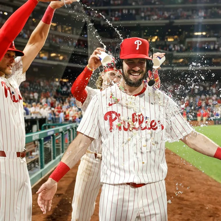 Phillies David Dahl gets a water bath from teammates Alec Bohm left and Bryson Stott after beating the Brewers 3-1 at Citizens Bank Park in Philadelphia, Monday, June 3, 2024