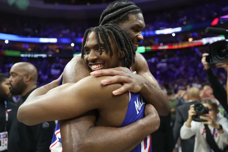 Philadelphia 76ers guard Tyrese Maxey hugs teammate Joel Embiid after their NBA play-in tournament win against the Miami Heat at the Wells Fargo Center in Philadelphia on Wednesday, April 17, 2024.