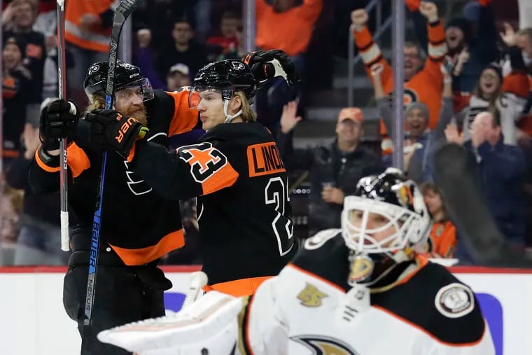 Flyers left wing Oskar Lindblom celebrates his first-period goal with teammate right wing Jakub Voracek past Anaheim Ducks goaltender Chad Johnson.