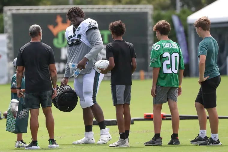 Fans waited to get signatures from Eagles defensive tackle Jordan Davis (90) at the end of training camp at the NovaCare Complex on Saturday.