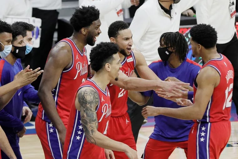 76ers players celebrate with Tobias Harris, far right, after he hit the winning shot against the Lakers.