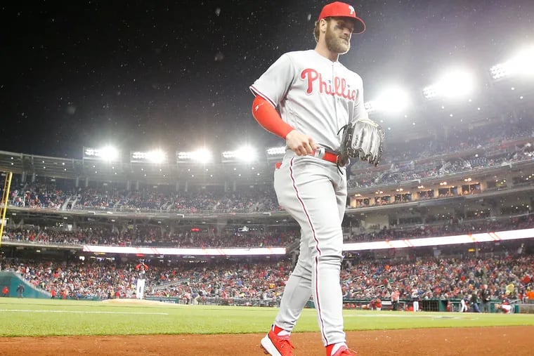 Phillies right fielder Bryce Harper runs into the Phillies dugout after the first-inning against the Washington Nationals on Tuesday, April 2, 2019 in Washington D.C.