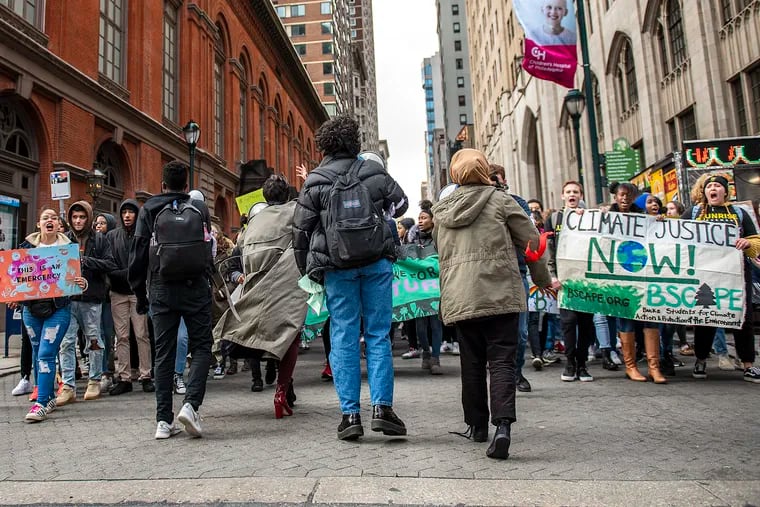 People march at the Youth Climate Change Strike at City Hall in Philadelphia, Pa, on Friday, Dec. 6, 2019. Philadelphia schools allow students to miss school to protest.