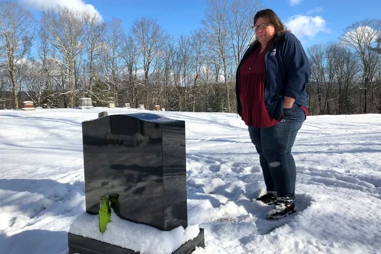 This December photo shows Deb Walker visiting the grave of her daughter, Brooke Goodwin in Chester, Vt. Goodwin, 23, died in March 2021 of a fatal overdose of the powerful opioid fentanyl and xylazine, an animal tranquilizer that is making its way into the illicit drug supply.