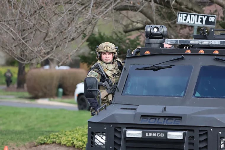 A police officer leaves the Headley Trace development in an armored vehicle in Newtown Township, Bucks County. Police on Sunday responded to a barricaded situation. Residents were asked to shelter in place.