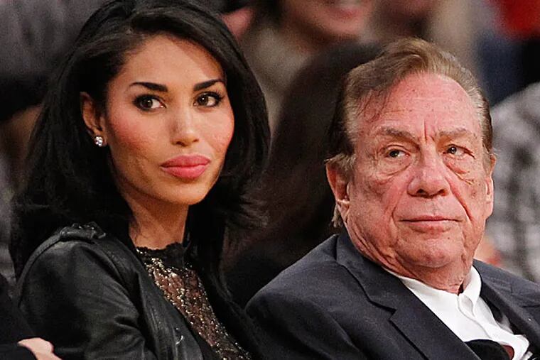Clippers owner Donald Sterling and V. Stiviano. (Danny Moloshok/AP)
