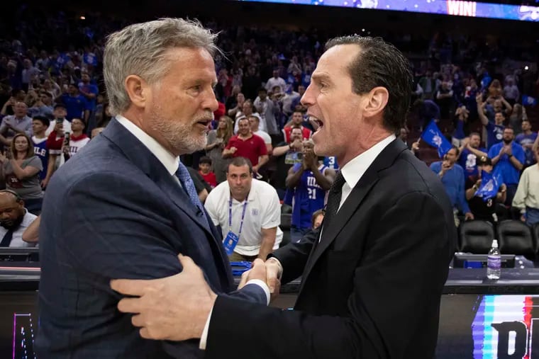 76ers coach Brett Brown (left) talks with Brooklyn Nets coach Kenny Atkinson after Game 5 of their playoff series last year.