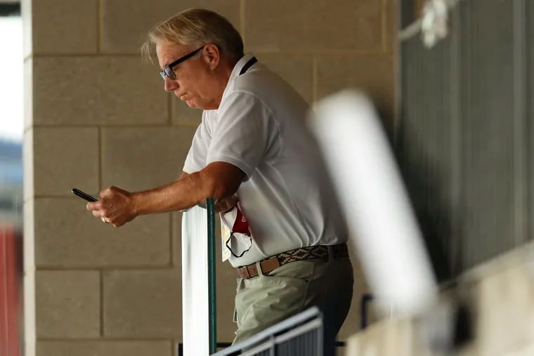 Phillies President Andy MacPhail looks at his phone while the Phillies played the New York Mets on Sunday, August 16, 2020 in Philadelphia.