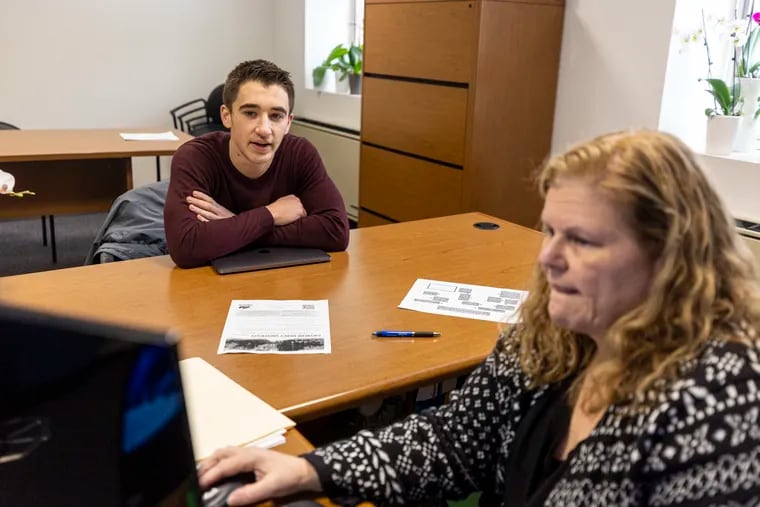 Kimberly Boyd, dean of retention and student success, helps Zackery Donlen, 21, a junior accounting major from Lancaster, with his plans to transfer to Gwynedd Mercy University after Cabrini closes in June.