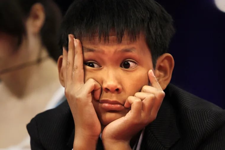 Vothom Son Lu, 11, of Camden, N.J., listens to fellow competitors
while onstage at the 2010 Scripps National Spelling Bee in
Washington, on June 3, 2010.