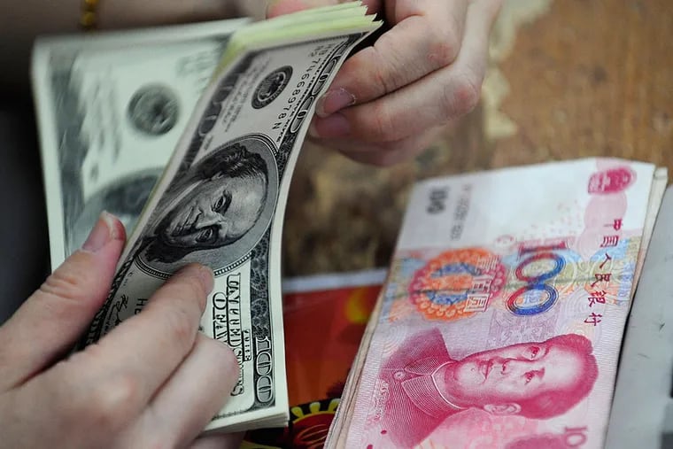 The yuan and the dollar: Analysts are debating the effects of China's devaluing of its currency after its market crash. AP