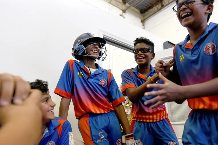 From left, Tanush Apte, 11; Mihir Ganguli, 14; Shiv Nair, 13; and Govind Mohandas, 13, during a break at cricket practice in Sterling, Va. KATHERINE FREY / Washington Post