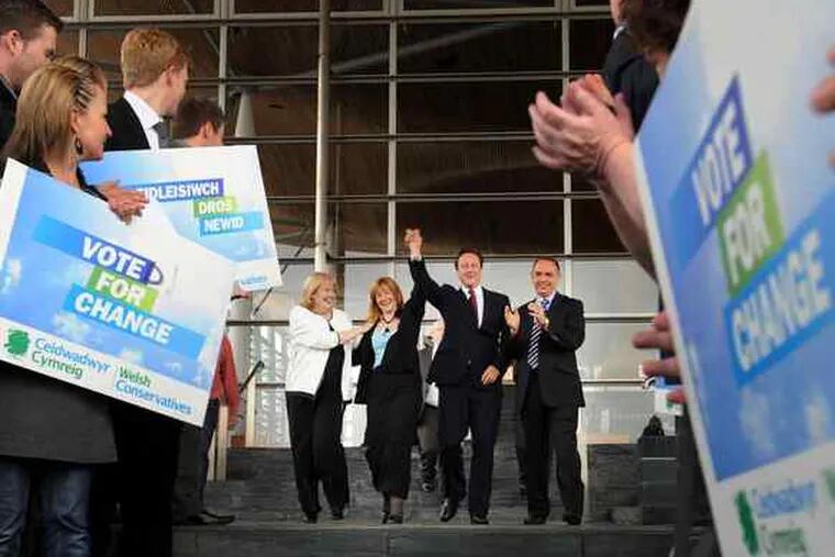 Conservatives David Cameron (center right) , the party leader , and Kay Swinburne (center left), a member of European Parliament from Wales, acknowledge supporters yesterday.