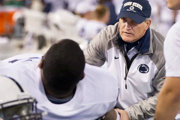 Penn State team physician Scott Lynch aiding guard Chasz Wright during a game against Maryland on Oct. 24, 2015.