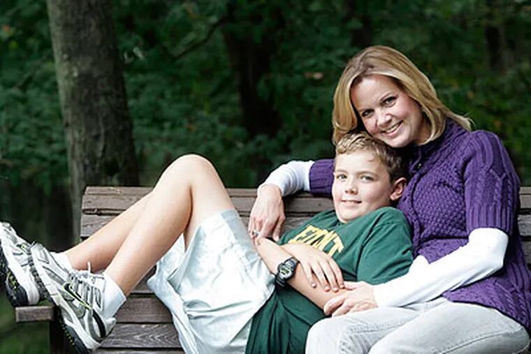 Jeanene Johnston and son Griffin in the backyard swing at their home in Hockessin, Delaware Friday. Jeanene was laid off last January but has just found work. (Bonnie Weller / Staff Photographer)