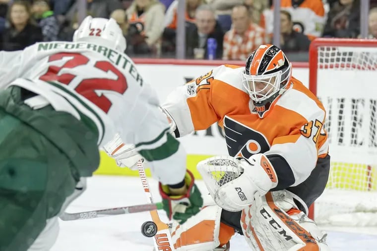 Brian Elliott makes a save against Minnesota’s Nino Niederreiter during the third period of the Flyers’ 1-0 loss Saturday.