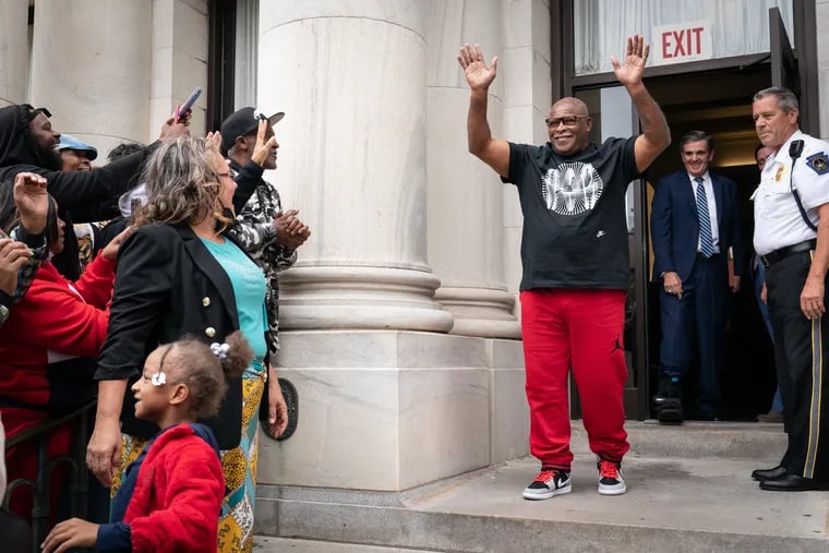 Rosemary Simmons, left, looks on as her husband Leroy Evans, center, exits the courthouse in Media, Friday, September 30, 2022. Evans was released from a life sentence for murder after serving more than 40 years in prison.