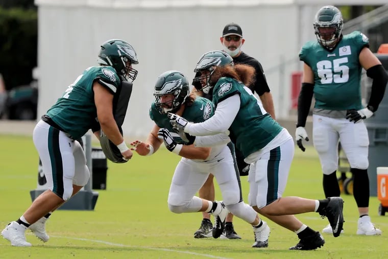 Eagles center Jason Kelce (center) and tackle Prince Tega Wanogho (right) engage with defensive end Daeshon Hall at practice on Wednesday.