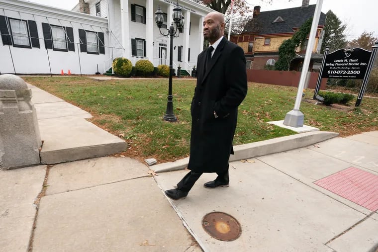 Leychawne Johns, in front of Lewis M. Hunt-Irving Funeral Home in Chester, a building he co-owns but was kicked out of after he lost his funeral trainee license.