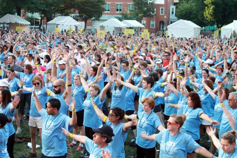 About 1,700 participants stretch to music before the Out of the Darkness Overnight Walk in Washington. The American Foundation for Suicide Prevention's walk raises funds for suicide awareness.