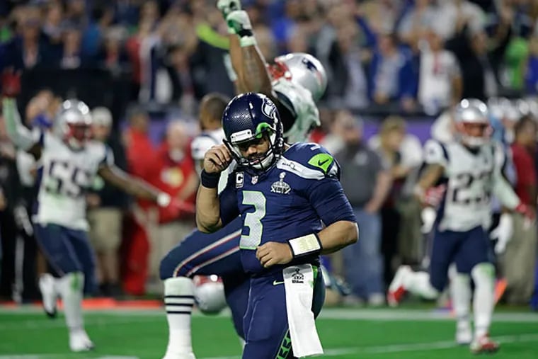 Seattle Seahawks quarterback Russell Wilson (3) reacts after throwing an interception to New England Patriots strong safety Malcolm Butler during the second half of NFL Super Bowl XLIX football game Sunday, Feb. 1, 2015, in Glendale, Ariz. (AP Photo/David Goldman)
