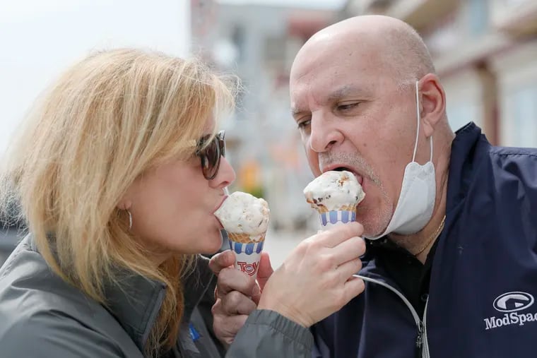 Gina and Dom DiGiacomo of Sea Isle City and Gloucester Twp. share their ice cream cones while walking in Cape May, NJ on May 3, 2020. Cape May opens its beaches amid the coronavirus (COVID-19) pandemic.