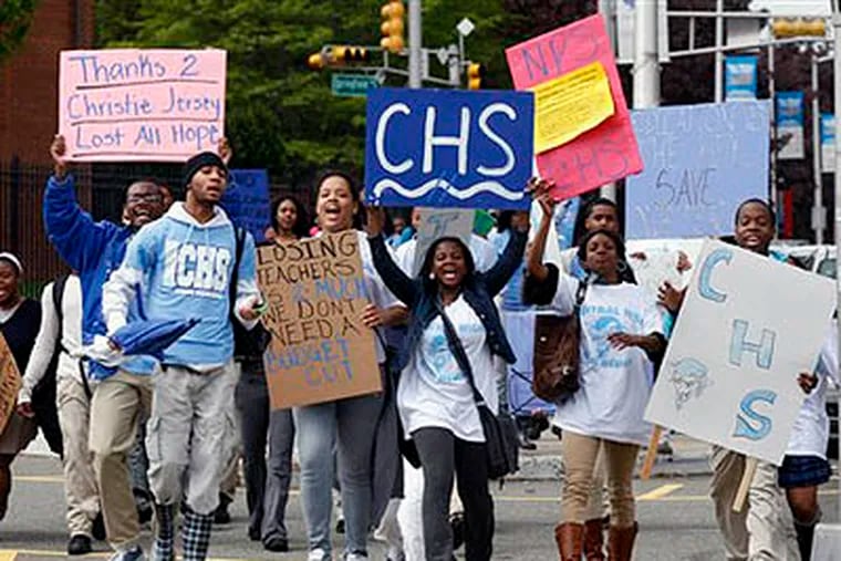 Cental High School students hold signs as they march to administrative offices  in Newark, N.J., at about 11 a.m., Tuesday, after walking out of classes. Similar protests were simultaneously throughout the state. (AP Photo / Mel Evans)
