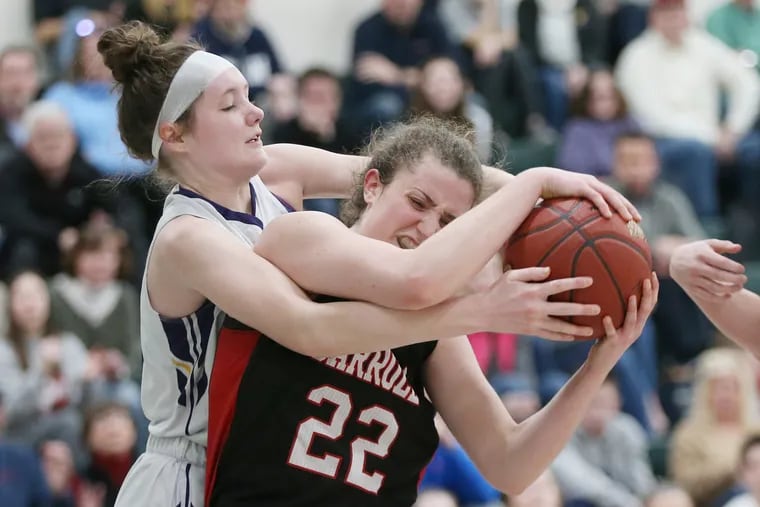 Mount St. Joseph's Kelly Rothenberg fights for the ball with Archbishop Carroll's Erin Sweeney (22) during their PIAA Class 5A first-round playoff game at Methacton High School in Eagleville, Pa., on Saturday. Archbishop Carroll defeated Mount St. Joseph, 47-41.