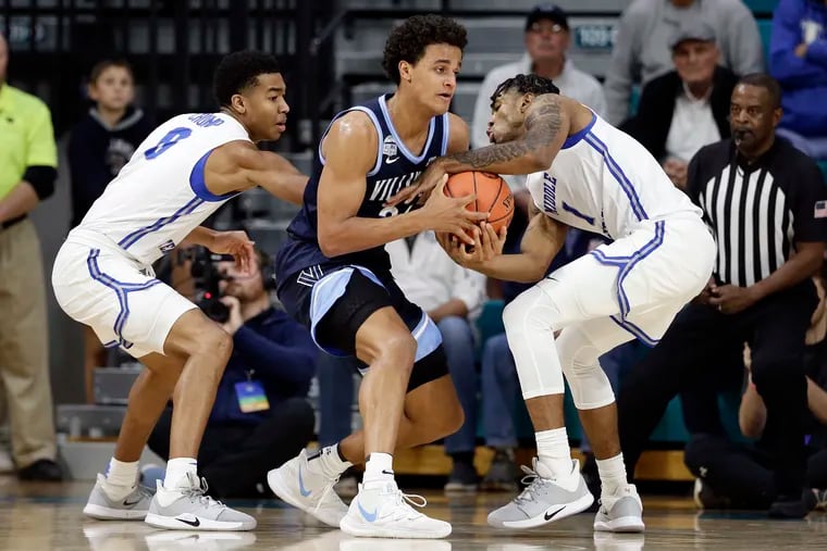 Middle Tennessee State guard Anthony Crump (0) and forward Tyler Millin (1) pressure Villanova forward Jeremiah Robinson-Earl during the first half.
