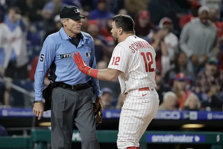 The Phillies' Kyle Schwarber argues with the home plate umpire after he was called out on strikes in the ninth inning against the Brewers.