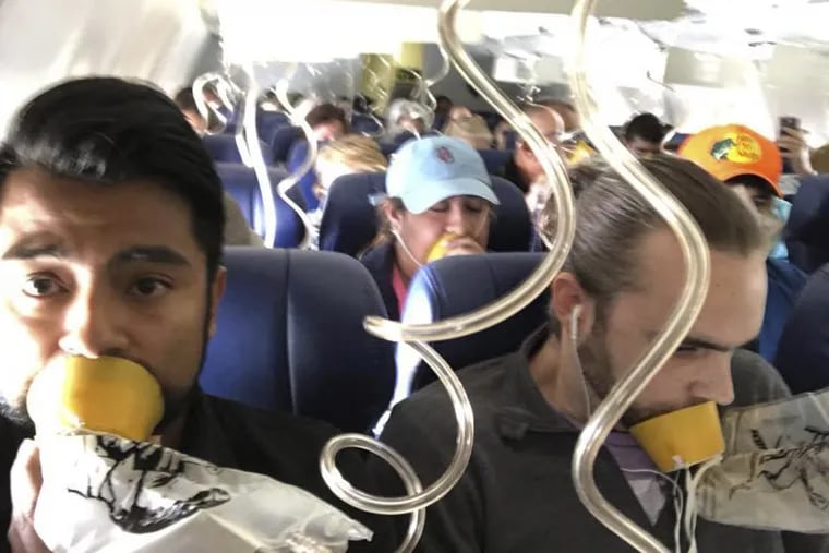 Marty Martinez, left, with other passengers after a jet engine blew out on the Southwest Airlines Boeing 737.