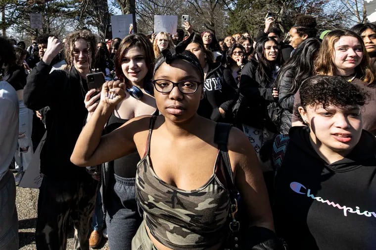 Alexis Wallace, age 16, raises her fist along other students during a Black Lives Matter protest outside Collingswood High School in Collingswood, N.J. Wednesday, Feb. 8, 2023.