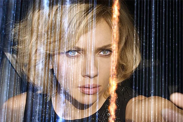 Scarlett Johansson stars in "Lucy," smuggling a new, high-tech designer drug into Taipei when the contraband accidentally seeps into her bloodstream, turning her into a super-powered, super-brainy fighting machine. (Universal Pictures)