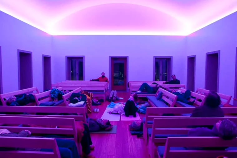 People watch an art light installation by internationally known artist James Turrell at Chestnut Hill Friends Meetinghouse. October 23, 2013 ( RON TARVER / Staff Photogapher )