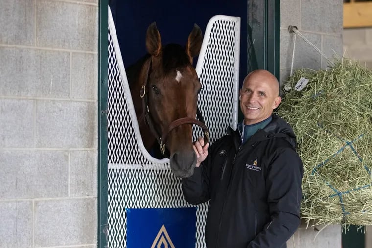 Terry Finley part-owner of Flightline, with the colt, at Keeneland Race Course in Lexington, Ky. Flightline is preparing for the Breeders' Cup Classic at Keeneland, where the undefeated colt is expected to be heavily favored.