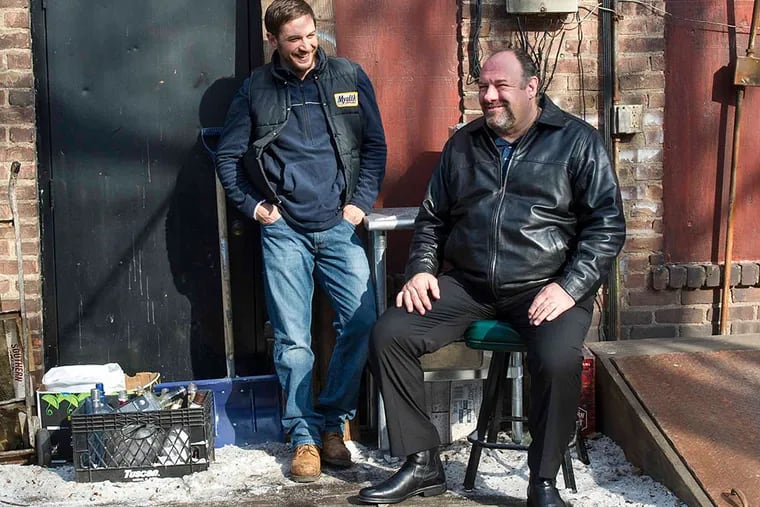 Tom Hardy is barkeep Bob (left) and James Gandolfini, in a swan-song role, is Cousin Marv, who sold his pub to a Chechen gang. Fox Searchlight