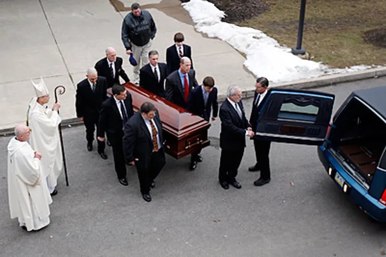 Pallbearers including Joe Paterno's son Scott (front left) carry his casket to a hearse before the procession through the Penn State campus. "It was simple in a Joe way," former Nittany Lions star Ki-Jana Carter said of the funeral. (David Maialetti / Staff Photographer)