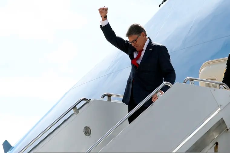 Energy Secretary Rick Perry gestures as he arrives on Air Force One with President Donald Trump at Naval Air Station Joint Reserve Base in Fort Worth, Texas, on Thursday.
