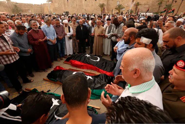 Mourners gather for funeral prayers for fighters killed by warplanes of Field Marshal Khalifa Hifter's forces, Wednesday, April 24, 2019 in Tripoli, Libya. A top Russian diplomat has called on the self-styled Libyan National Army to cease fire and stop its advance on the Libyan capital.(AP Photo/Hazem Ahmed)