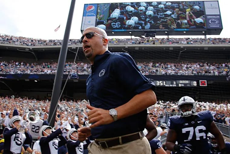 Penn State head coach James Franklin, center, leads his team onto the
field at Beaver Stadium before an NCAA college football game against
Akron in State College, Pa., Saturday, Sept. 6, 2014. Penn State won
21-3. (Gene J. Puskar/AP)